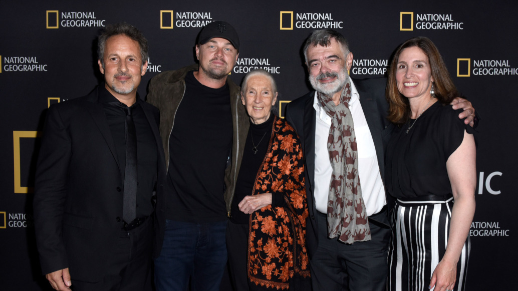 Five people, including Leonardo DiCaprio, stand together at a National Geographic event. They are posed in front of a branded backdrop for "Sea of Shadows," dressed in formal attire, and smiling at the camera, capturing a moment of unity and purpose.