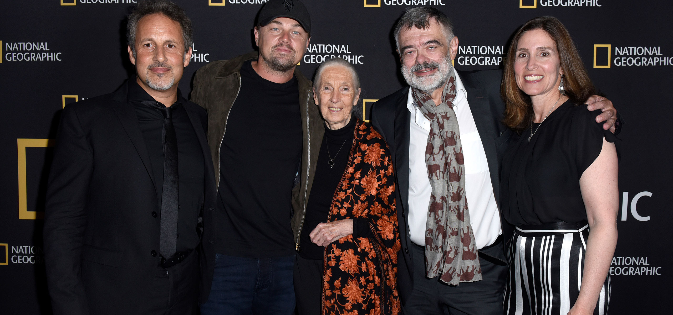 Five people, including Leonardo DiCaprio, stand together at a National Geographic event. They are posed in front of a branded backdrop for "Sea of Shadows," dressed in formal attire, and smiling at the camera, capturing a moment of unity and purpose.