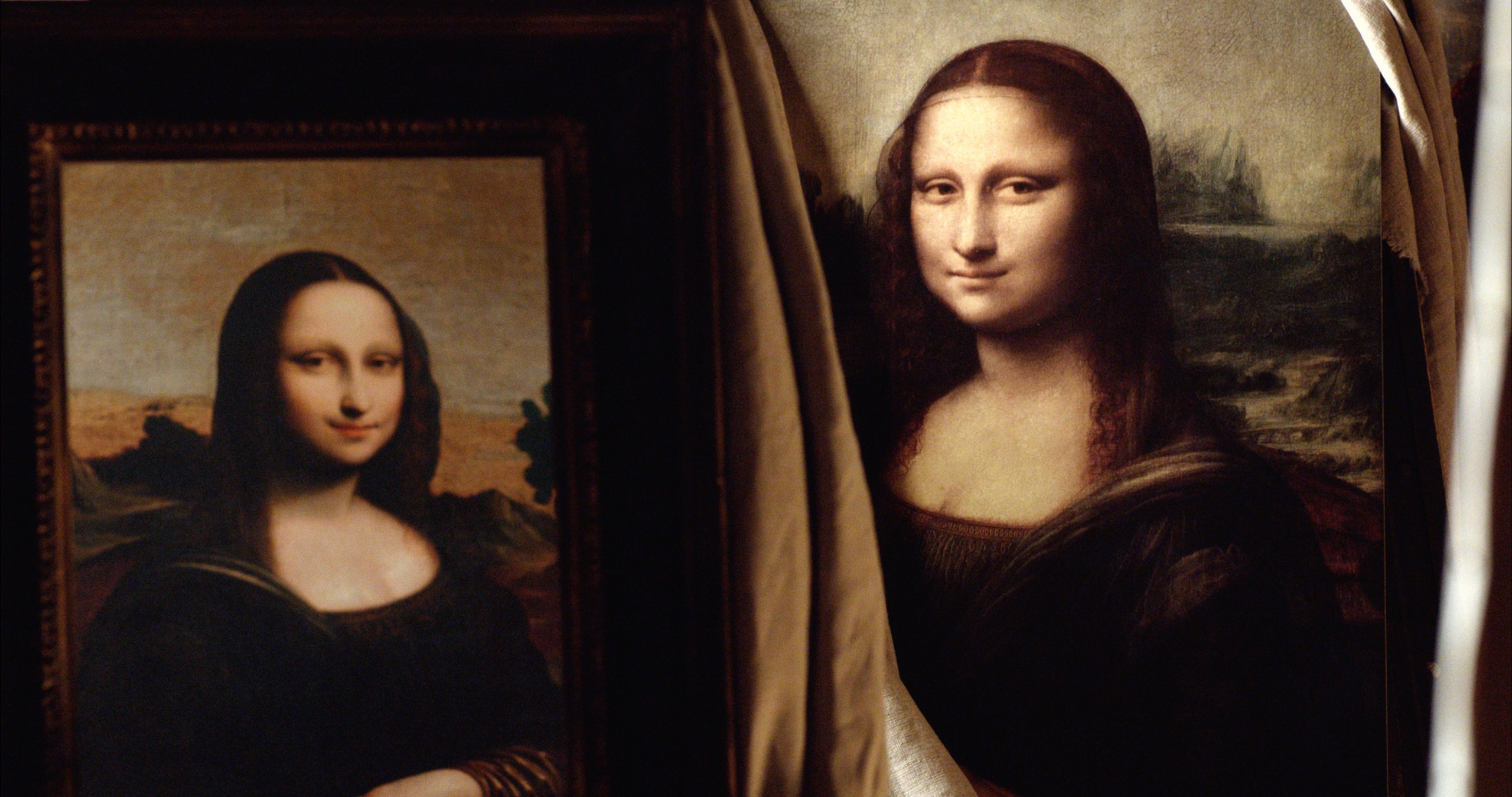 Two versions of the iconic Mona Lisa are displayed side by side. The original masterpiece is on the right, partially obscured by a curtain, while a reproduction or alternate version sits on the left. Both portray a woman with a serene expression set against a tranquil landscape backdrop.