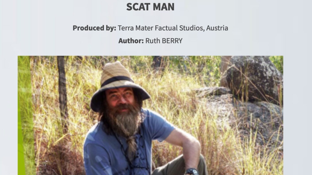 A bearded man sits outdoors, donning a wide-brimmed hat, blue shirt, and tie amidst trees and rocks. Above him, text reads Best Science Pitch 2019 - Scat Man. Produced by Terra Mater Factual Studios, Austria, with author Ruth Berry. Featured at Sunny Side of the Doc.