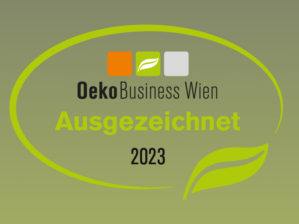 Logo for OekoBusiness Wien features three squares in orange, green, and gray with a leaf icon, symbolizing a commitment to green business. The text reads Ausgezeichnet 2023 in bright green, with a leaf graphic at the bottom. The background is a green gradient.