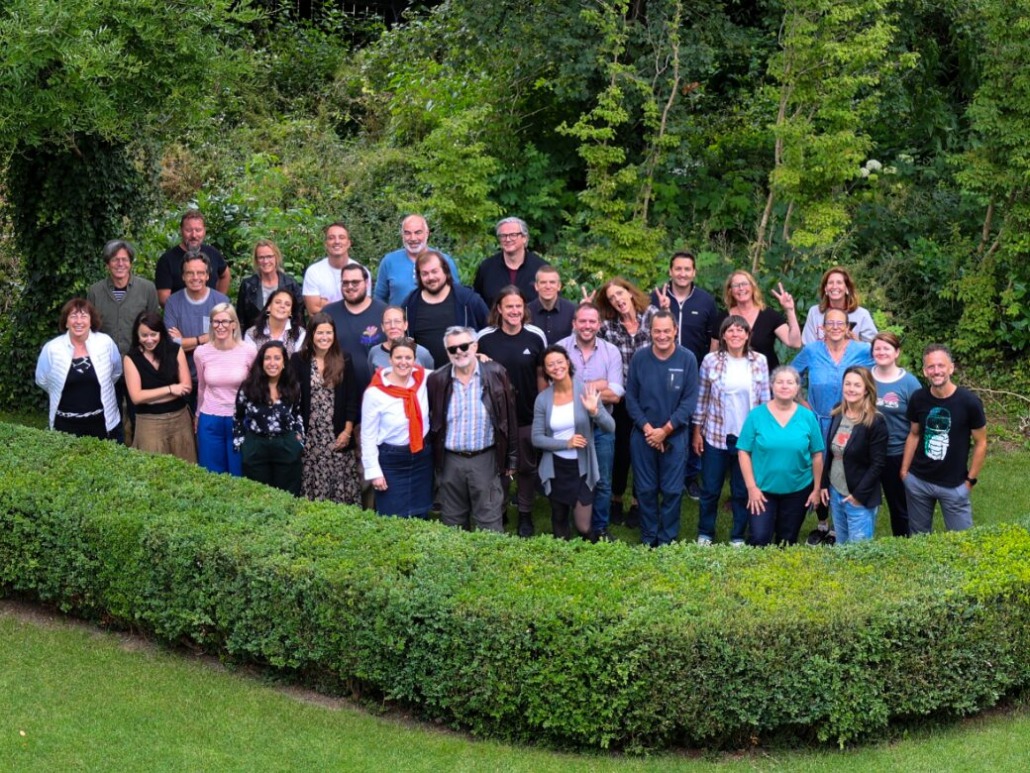 Terra Mater team standing in the garden, photographed from above