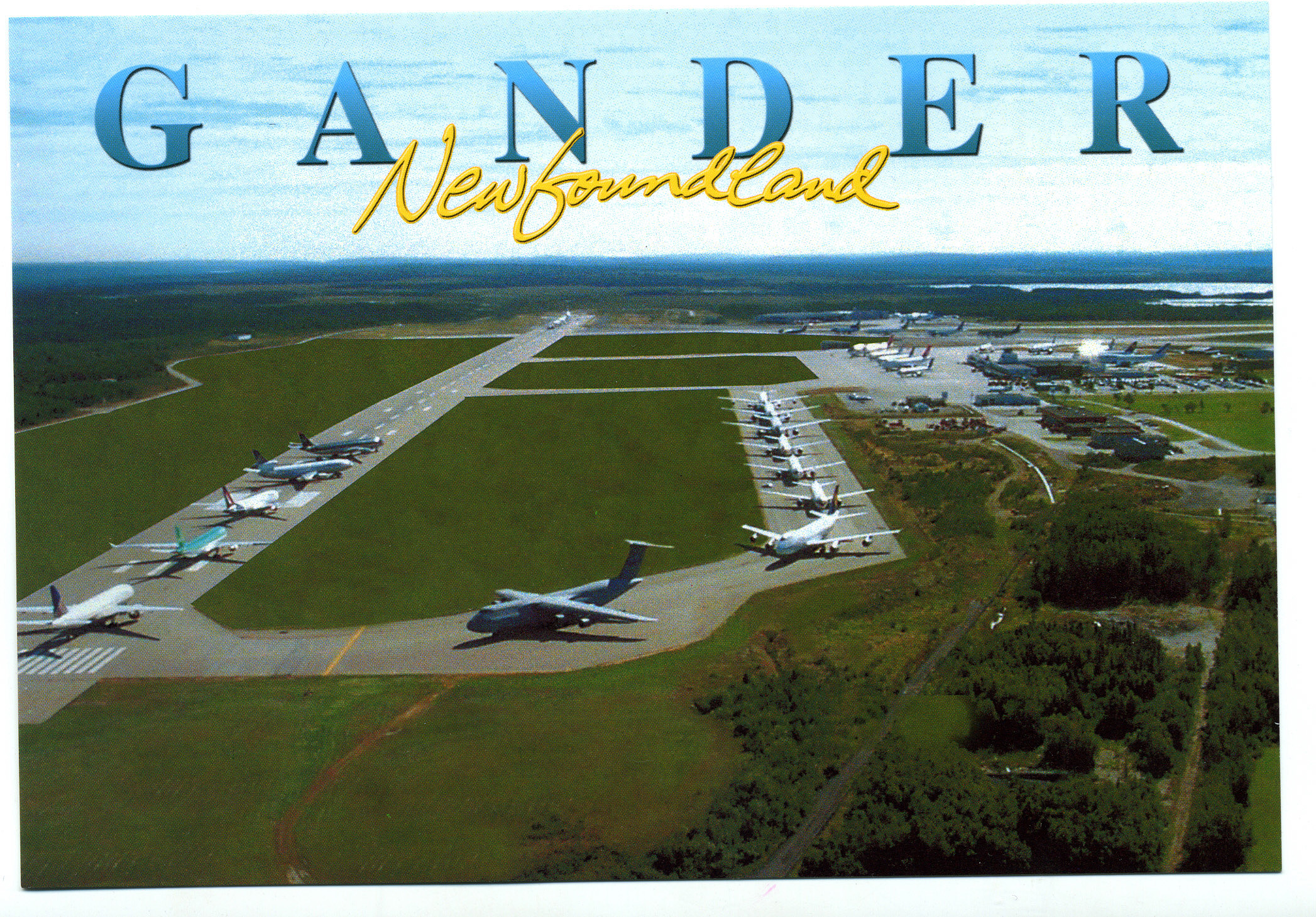 Aerial view of Gander International Airport in Newfoundland, where unexpected visitors once found solace. Several airplanes are parked on the tarmac, surrounded by lush green fields and forested land. The words Gander Newfoundland are written across the top, evoking memories of 9/11s silver linings.